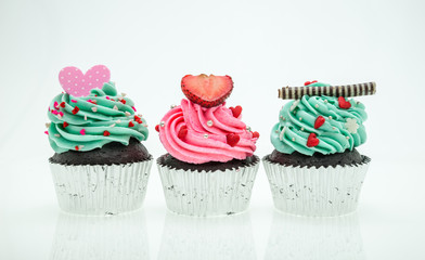 colorful cupcakes with beautiful decoration over white backgroun