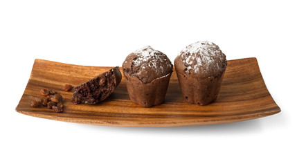 Сhocolate muffins on a wooden plate