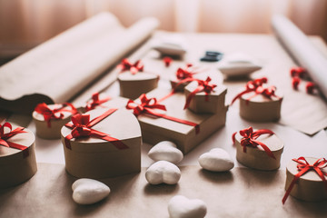 Packing stylish gifts with red ribbon.