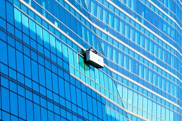 Fensterpuzer bei der Arbeit an einer Hochhausfront aus Glas