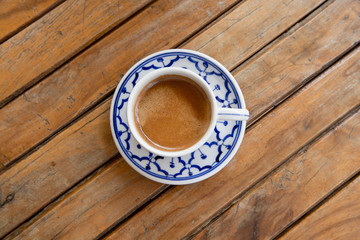 cup of espresso on a wooden background table.