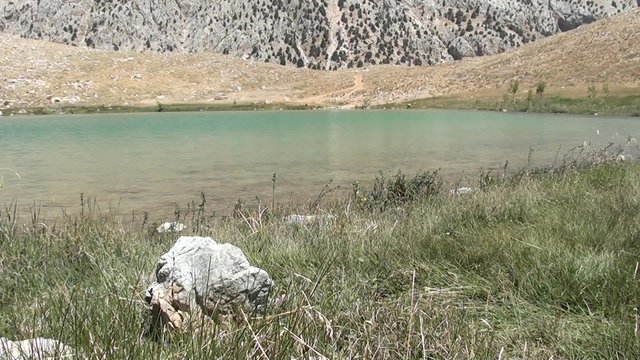 Green crater lake in hot summer day
