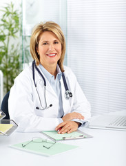 Mature doctor woman in a clinical office.