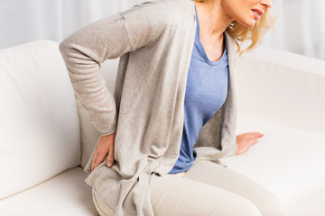 close up of woman suffering from backache at home