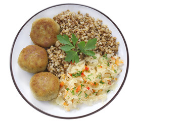 Chicken cutlets with buckwheat and salad  with sauerkraut, carrots and paprika