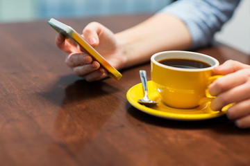 close up of woman with smartphone and coffee