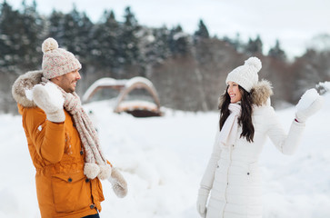 Fototapeta na wymiar happy couple playing snowballs in winter