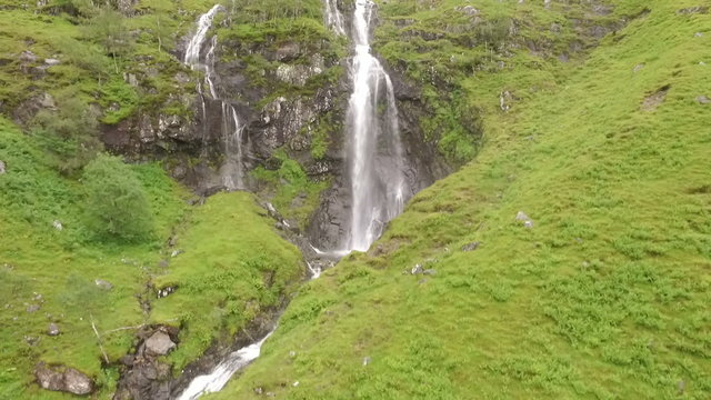 Stunning aerial / drone shot of a waterfall in Glencoe in the Scottish highlands
