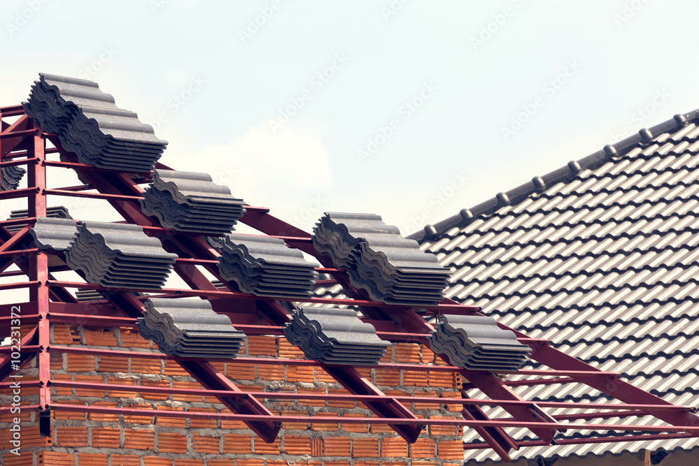 Wall mural black tile roof on residential building construction house