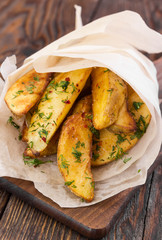 Potato with dill on wooden background