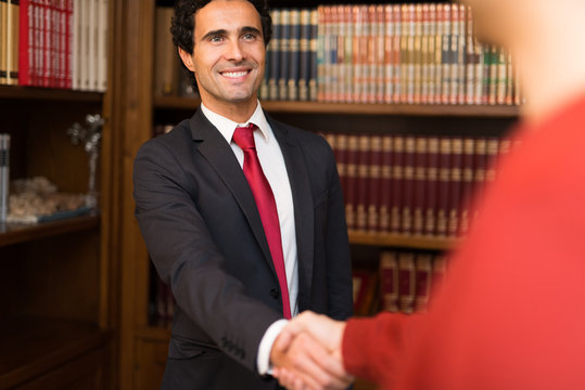 Businessman giving an handshake to a customer