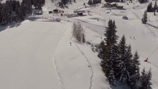 Aerial shot of people skiing in a french ski resort in the Alps
