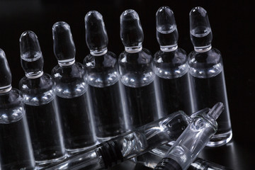  medical ampoules on a black background
