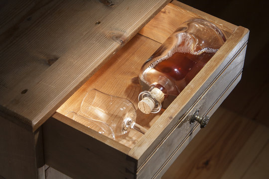 Bottle brandy and glasses in a drawer