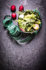 Fototapeta na wymiar Diet concept, salad ingredients on black background . healthy food