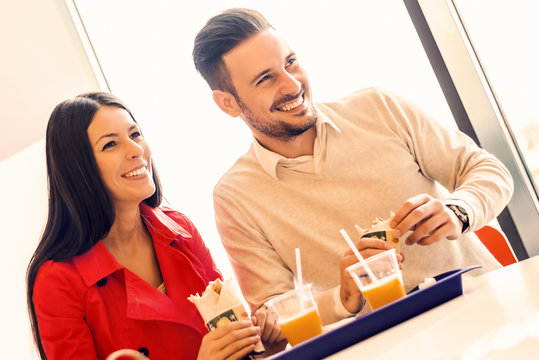 Couple eating in fast food restaurant