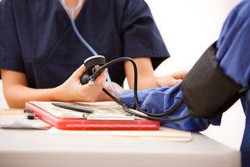 Doctors: Taking Patient Blood Pressure