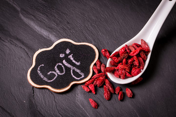 Goji berries,healthy superfood,diet concept , on black stone