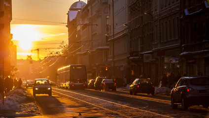 Sunset city. Tram, cars, sun, city.
