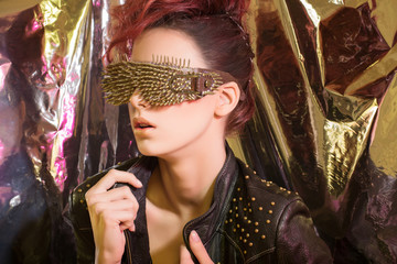 \young girl with red hair wearing glasses with gold spikes in th