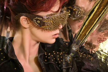 \young girl with red hair wearing glasses with gold spikes in th