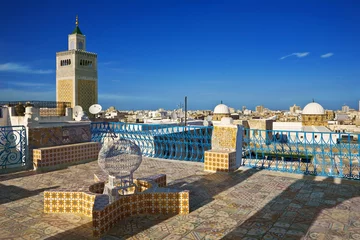Wall murals Tunisia Tunisia. Tunis - old town (medina). Terrace of Palais d'Orient with ornamental wall covered tiles. There is minaret Zitouna Mosque on left side