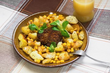 Beefburger with fried potato with maize