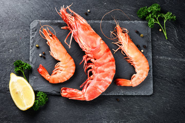 Fine selection of jumbo shrimps for dinner on stone plate
