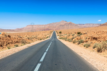 Fototapeta na wymiar Endless road in Sahara Desert with blue sky,Morocco Africa