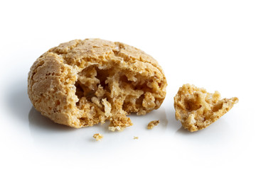 Detail of one broken Italian amaretti biscuit isolated on white