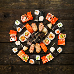 Set of sushi, maki and rolls isolated at wood