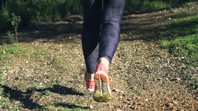 female legs jogging in park, super slow motion
