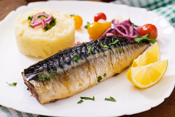 Baked mackerel with herbs and garnished with mashed potatoes and pickled vegetables