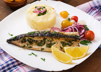 Baked mackerel with herbs and garnished with mashed potatoes and pickled vegetables