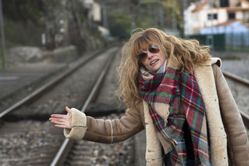Young adult woman in casual fashion on train tracks © carballo