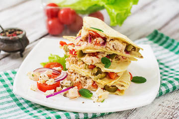Mexican Quesadilla wrap with chicken, olives, sweet pepper and salad.