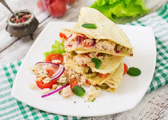 Mexican Quesadilla wrap with chicken, olives, sweet pepper and salad.