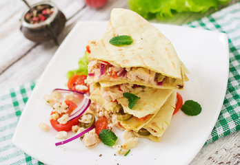 Mexican Quesadilla wrap with chicken, olives, sweet pepper and salad.