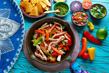 chicken fajitas in a pan chili and sides Mexican