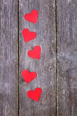 Valentines Day background with red hearts on old wooden backgrou