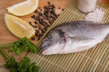  fresh fish with lemon, butter, salt and pepper