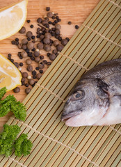  fresh fish with lemon, butter, salt and pepper