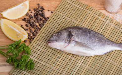 fresh fish with lemon, butter, salt and pepper