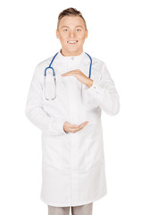 Medical doctor in white coat with stethoscope holding something