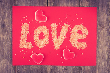 Valentines Day card - text LOVE from small pebbles with small he