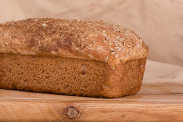 f bread with cereals on a fabric background brown color.