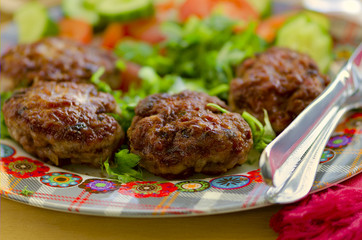 Lamb and veal cutlets with fresh vegetables salad