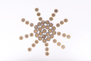Symbol of sun made from Polish zloty coins. Symbolizes good fortune in business, large income, earnings, or winning the lottery.