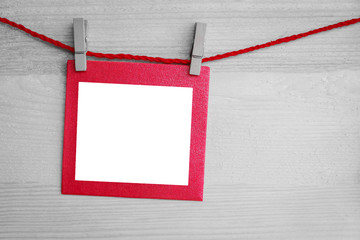heart and blank paper card on wooden background, Selective red color.