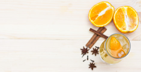 Fototapeta na wymiar Lemonade with orange and spices on the table